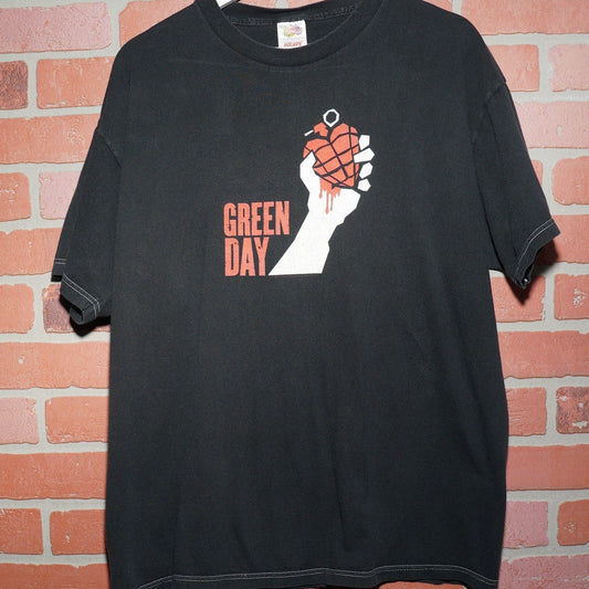 Black t-shirt with a graphic design on a brick background